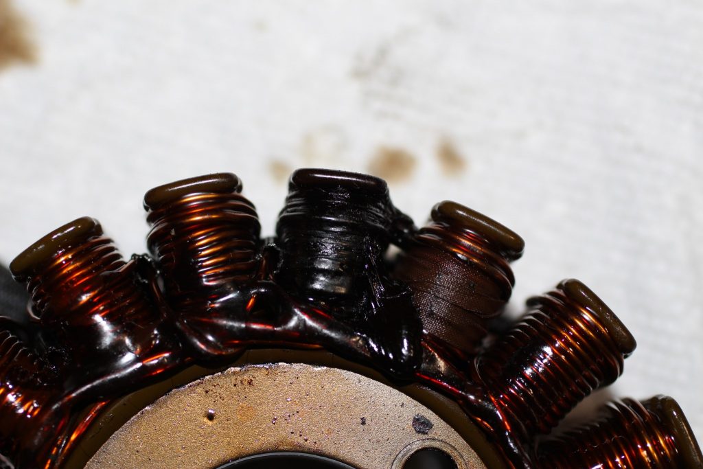 Photo of black wires around one coil on the stator