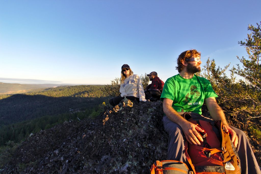 People sitting on the Butte waiting for the eclipse